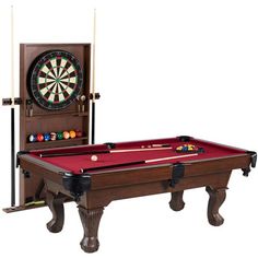 a pool table with a red cloth on it and a clock mounted to the wall