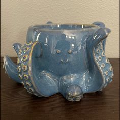 an octopus planter sitting on top of a wooden table