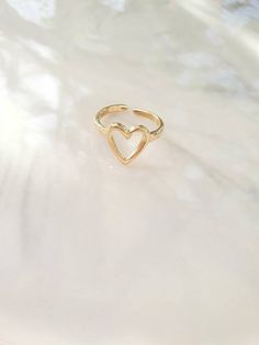 Please read before purchasing, thank you! Handmade Jewelry by me <3 ------------- DESCRIPTION------------- This romantic rings, are made from gold plated brass.  This heart ring is the symbol of love.   --------------- SIZE -------------  Adjustable size, fits perfectly size 6 to 7 USA   Internal diameter 17cm Nickel Free,  If you have any questions about the fit of the ring please don't hesitate to contact me! --------------- PACKAGING -------------- The SweeThings Jewelry will come with a beau Dainty Gold Heart Ring For Valentine's Day, Minimalist Gold Signet Ring For Valentine's Day, Minimalist Heart-shaped Rings For Valentine's Day, Valentine's Day 14k Gold Heart Signet Ring, Valentine's Day Heart-shaped 14k Gold Signet Ring, Romantic Rings, For My Daughter, Ring Minimalist, Ring Dainty