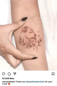 a woman's arm with a tattoo on it and a bear sitting in the middle