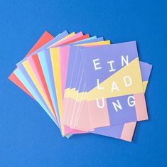 several pieces of colored paper with the words finn ladling printed on them against a blue background