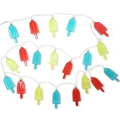 an assortment of ice cream lights are hanging from a white string on a white background