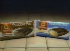 two packages of pudding piping sitting on top of a tiled floor next to each other