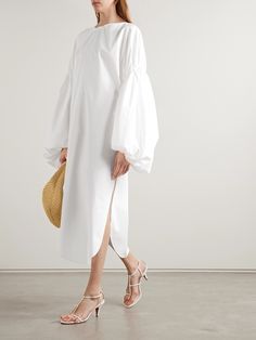 While able to be captured beautifully in images, the draping throughout Khaite's Spring '24 collection only feels more elegant in motion. This 'Zelma' dress is made from cotton-sateen that's gathered along the bubble sleeves for plenty of added volume. The splits in the curved hem reveal flashes of leg as you walk. Cotton Sateen Dresses, Leg Of Mutton Sleeve Dress, Mutton Sleeve, The Splits, Leg Of Mutton Sleeve, Bubble Dress, The Bubble, Sports Suit, White Midi Dress