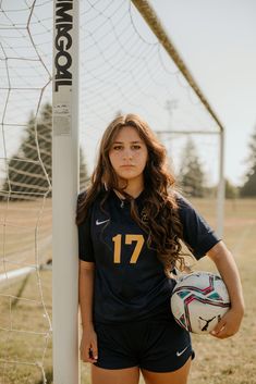 a female soccer player is posing for a photo