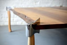 a close up of a wooden table with a metal handle on the top and bottom