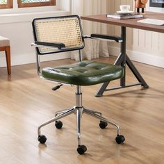 a green office chair sitting on top of a hard wood floor next to a computer desk