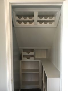 an empty closet with shelves and drawers