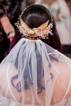 the back of a woman's head wearing a veil