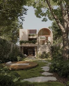 the house is surrounded by lush green trees and grass, with stepping stones leading up to it