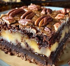 a piece of cake with pecans on top is sitting on a blue and white plate