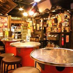 the interior of a bar with stools and tables