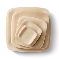 three square wooden plates stacked on top of each other in the shape of rectangles