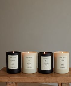 three candles sitting on top of a wooden table