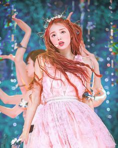 a girl with long red hair wearing a pink dress