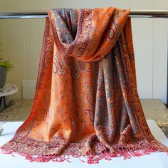 "Silk Paisley Pashmina Jacquard Long Scarf This beautiful pashmina is a classical paisley print scarf. It's a double layered warm scarf in rich red and orange colors, with gorgeous wide ornate borders on all four edges. It's also reversible - there's a different color on the opposite side of the scarf, making for TONS of wrapping possibilities! Layer it, fold it, pleat it - you can create the effect of a headband or of several scarves in one or simply use as a cover up to protect from chilly win Morocco Clothes, Wedding Shawls, Kashmiri Shawls, Art Scarves, Scarf Material, Silky Scarf, Pashmina Scarf, Warm Scarf, Red Silk