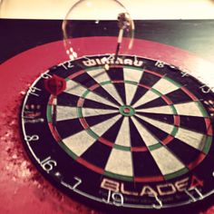 a close up of a dart board on a table