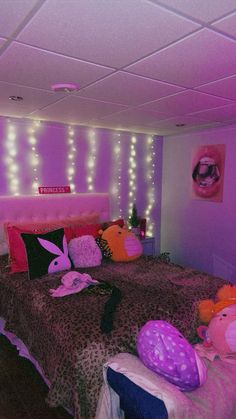 a bedroom with purple lights on the ceiling and pink bedspread in front of a leopard print comforter