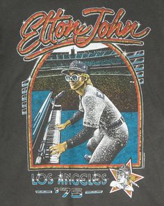 ELTON JOHN 1975 BASEBALL/PIANO TEE | Kingfisher Road | Online Boutique Elton John Graphic Tee, Retro Tshirt Design Graphics, Vintage Sports Tees, Elton John Aesthetic, Bar Shirts, Atomic Age Design, Vintage Tshirt Design, Vintage Shirt Design, Concert Style