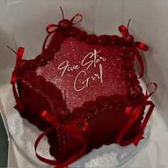 a heart shaped cake with red ribbon and writing on the side that says, give us god