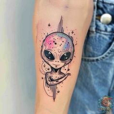 an alien tattoo on the arm