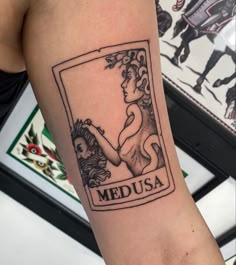 a woman's arm with a medusa tattoo on it