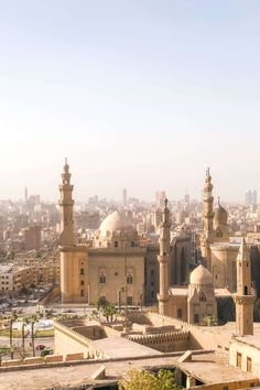 an aerial view of a city with tall buildings and minarets in the foreground