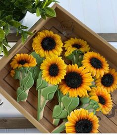 sunflower cookies in a wooden box on a table