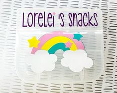 there is a plastic container with some stickers on it that says lorel's snacks