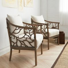 two chairs sitting next to each other on top of a hard wood floor