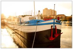 a boat is docked in the water at sunset