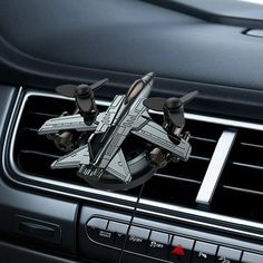 an air vent in the middle of a car with two fighter jets on it's dashboard