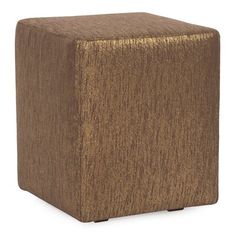 a brown cube ottoman sitting on top of a white floor