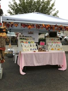 two scarecrows standing next to a table with cards on it