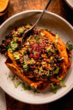 a white bowl filled with food on top of a wooden table