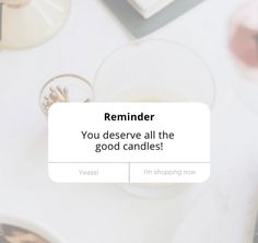 a white table topped with plates and cups filled with cake next to a text that reads reminder you deserves all the good candles