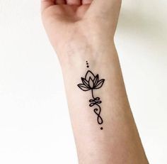 a woman's wrist tattoo with a flower on it