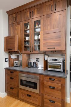 a kitchen with wooden cabinets and stainless steel appliances