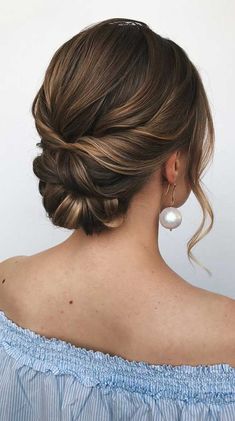 a woman with her hair in a low bun