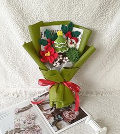 a bouquet of flowers sitting on top of a table next to an open photo album