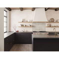 a kitchen with black cabinets and an island in front of the stove top is shown