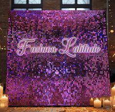 the sign for fashion latihande is lit up in front of some candles