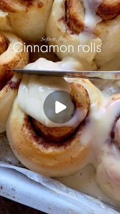 cinnamon rolls with icing being cut into pieces