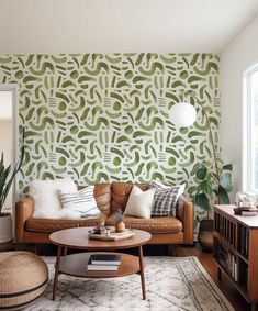 a living room with green and white wallpaper