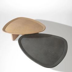 two wooden trays sitting on top of each other