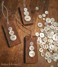 some buttons are laying on a wooden surface