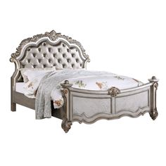 a bed with an ornate headboard and foot board