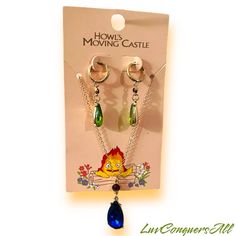 the lion and the mouse earrings are on display in front of a card with its packaging