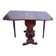 an old wooden table with two legs and a square top on the base is turned upside down