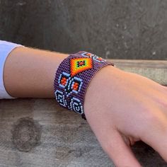 a person's hand with a beaded bracelet on it